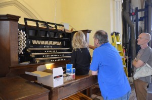 A young child sits at the Willis console