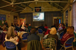 Volunteers watch Jacob in the organ video