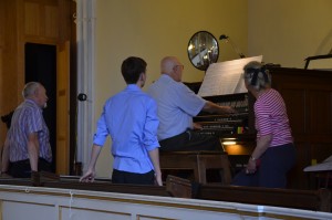 Jacob watches as a budding organist plays