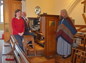 Anna Page, Dave King and Lesley Salter with the plaque on the organ about the project