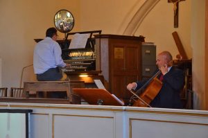Jonathan and James playing organ and cello in the gallery