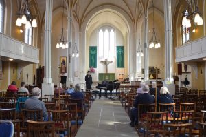 Adam Parrish introduces the first piano piece of the concert